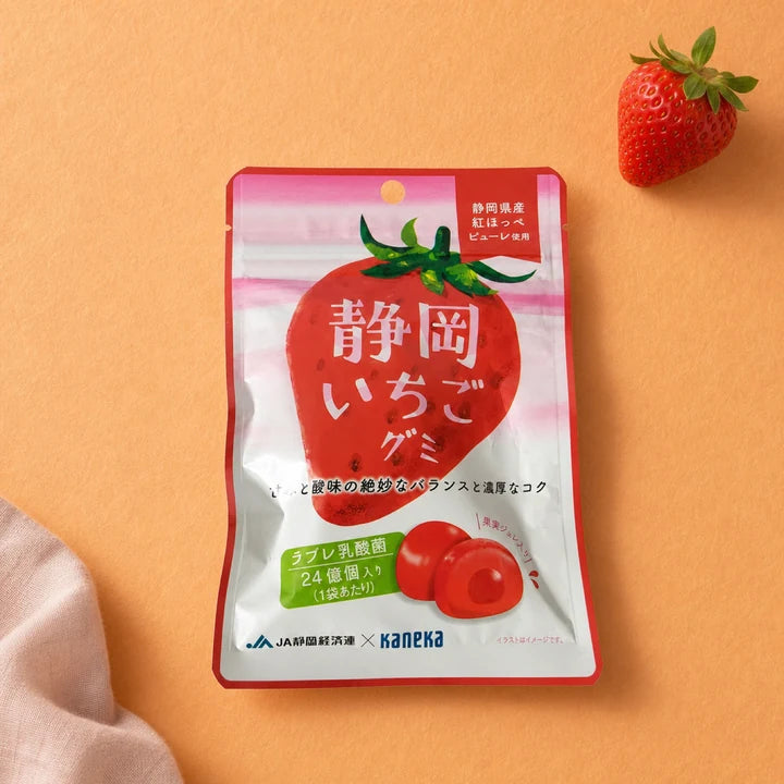 Shizuoka Strawberry Gummy package with strawberries on a soft red background
